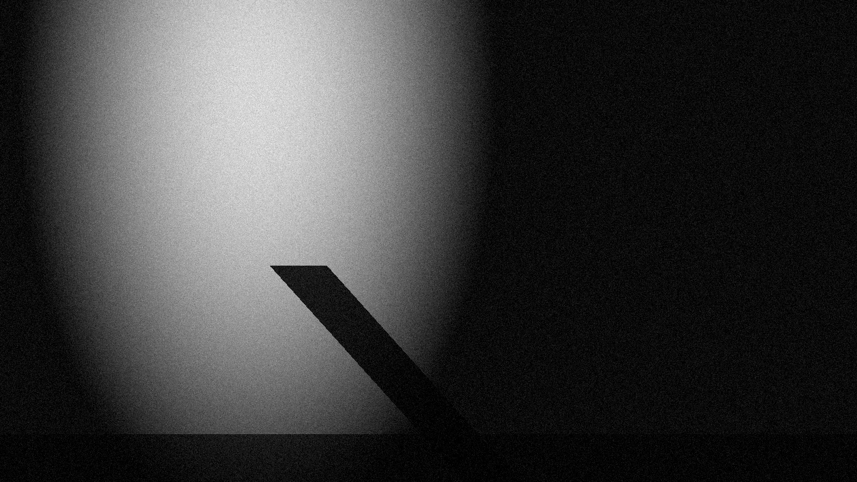 Un foco de luz sobre un suelo vacío con una sombra larga, en blanco y negro
